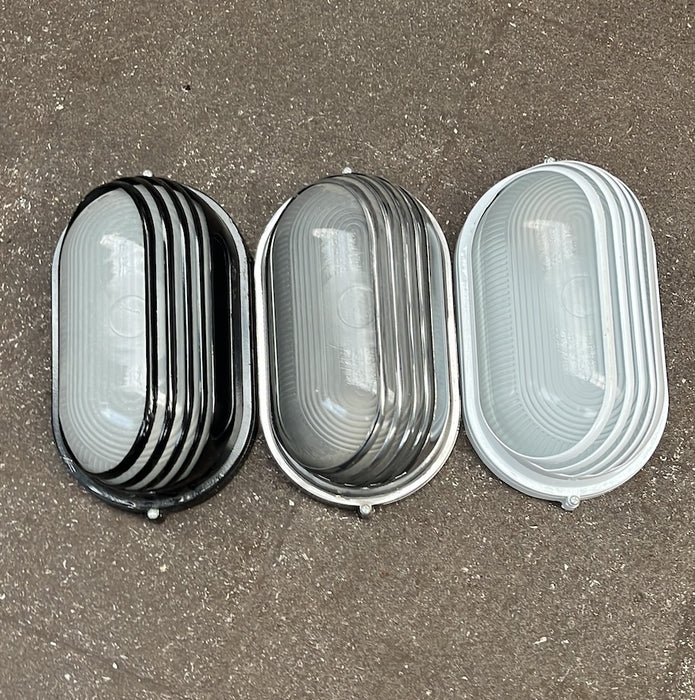 Oval aluminium bulkhead wall and ceiling light with frosted ribbed glass and louvred guard