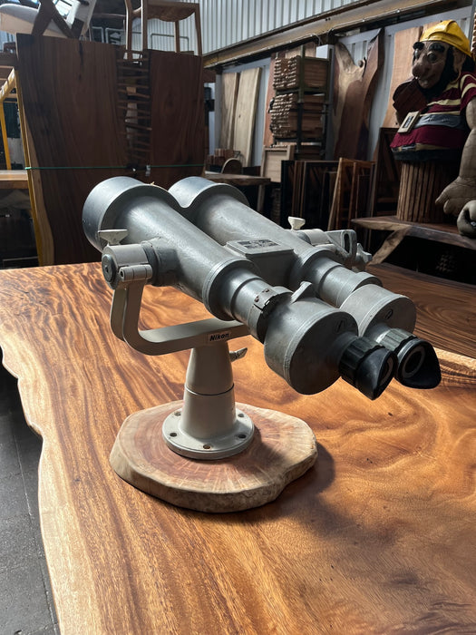Side view of a salvaged Nikon 20x120 binocular telescope showing the fork mount and wooden base