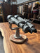 Side view of a salvaged Nikon 20x120 binocular telescope showing the fork mount and wooden base