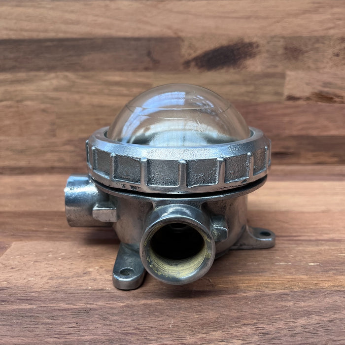 Reclaimed ship's bulkhead light showing mounting lugs and conduit entries