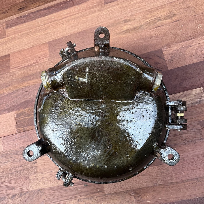 Salvaged iron round bulkhead light with weathered patina, genuine ship salvage