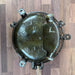 Iron round bulkhead light showing weathered patina and iron construction