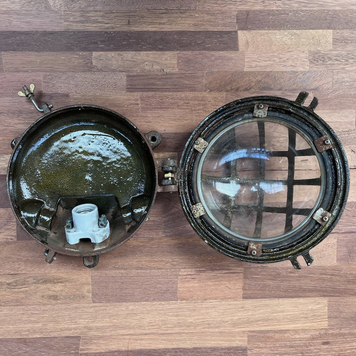 Salvaged bulkhead light shown against plain background