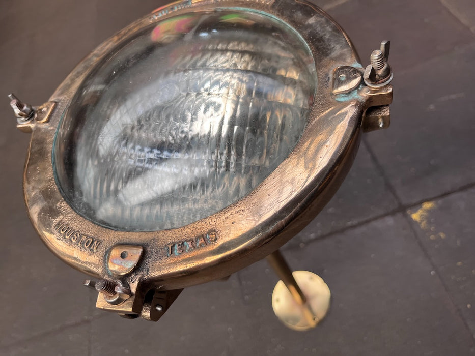 Close-up of cast Houston Texas lettering on polished brass Pauluhn spotlight bezel