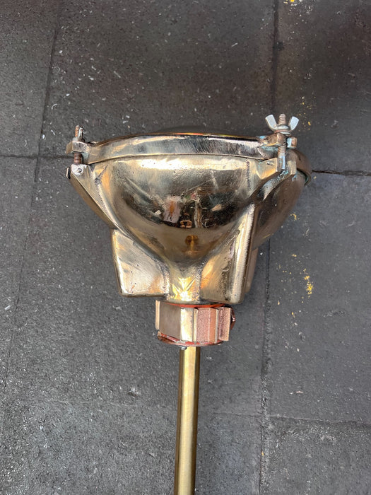 Rear of polished cast brass Pauluhn marine spotlight housing with brass drop rod