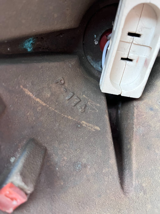 Inside the cast brass housing of a salvaged Pauluhn ship spotlight showing casting mark and lamp connector