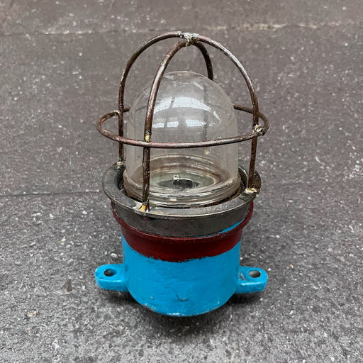 Side view of salvaged iron ship security light showing two cable entries and mounting tabs