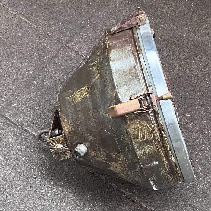 Side profile of salvaged VEB ceiling light with brass toggle clamp and top hanging bracket