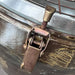 Close-up of brass toggle clamp and screw catch on vintage VEB industrial ceiling light