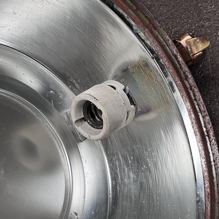 Close-up of original ceramic lamp holder inside vintage VEB steel ceiling light