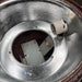 Inside of VEB industrial ceiling light showing polished reflector, ceramic lamp holder and internal mounting plates