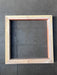 Close-up of the mitred end of a hardwood divider piece showing the grain and red-brown heartwood edge