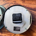 Kappa ship's clock with hinged bezel open showing rating plate Type SSC-320, 24V DC, and quartz movement