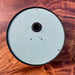 Back of Kappa salvaged ship's clock with sea green painted case, cable grommet and mounting holes