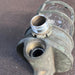 Salvaged brass marine cage light, angled view of glass dome neck and threaded cable entry