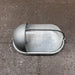 Black oval bulkhead light with eyelid shield and ribbed glass diffuser, front view