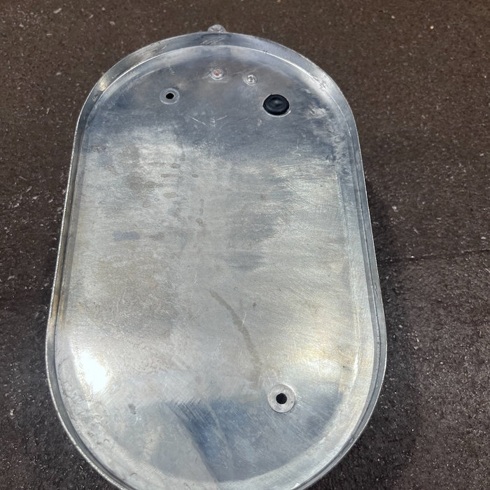Industrial oval bulkhead light with eyelid shield, angled view along the glass