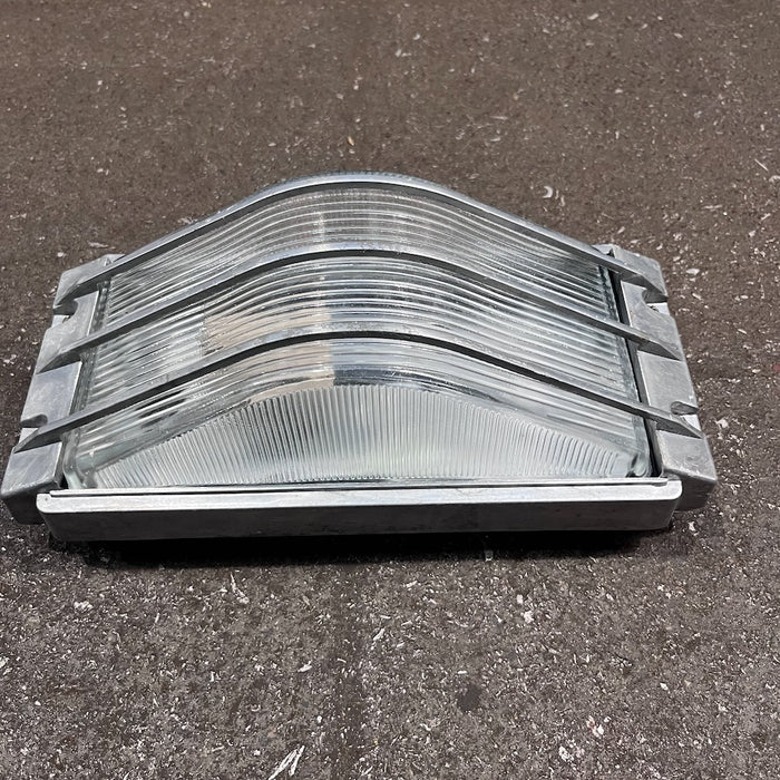 Aluminium marine bulkhead light with curved bar guard and ribbed glass