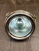 Inside of salvaged pendant light showing polished reflector and ceramic lamp holder