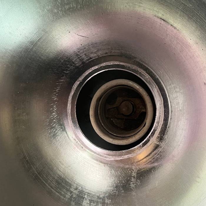 Salvaged spun steel pendant light, close-up of glass front clamp and wing nut fitting