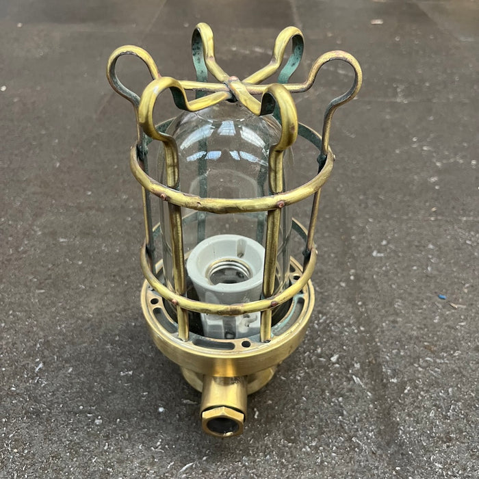 Ceramic lamp holder and threaded brass base of a Palazzoli passageway light