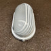 Back plate of black oval bulkhead light showing mounting and cable entry