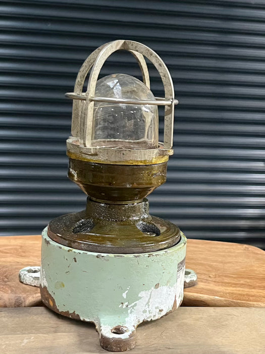Vintage ship's bulkhead light with blue cast iron base, two cable glands and chrome cage