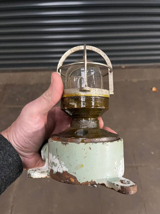 Reclaimed marine caged light with green painted cast iron base and brass collar