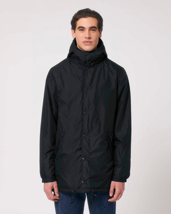 Stanley/Stella SX204 unisex padded parka jacket in Black, styled on model
